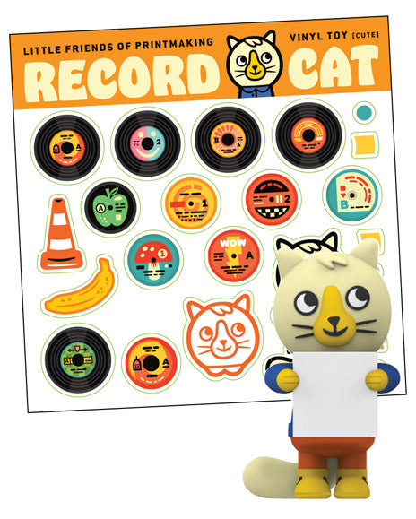 Toy figure of a cat character holding a vinyl record with interchangeable lables. 